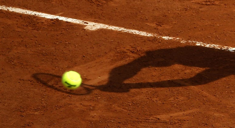 In this May 28, 2016 file photo, a player's shadow is pictured as he returns the ball during the French Open tennis tournament at the Roland Garros stadium, in Paris. In this May 28, 2016 file photo, a player's shadow is pictured as he returns the ball during the French Open tennis tournament at the Roland Garros stadium, in Paris.