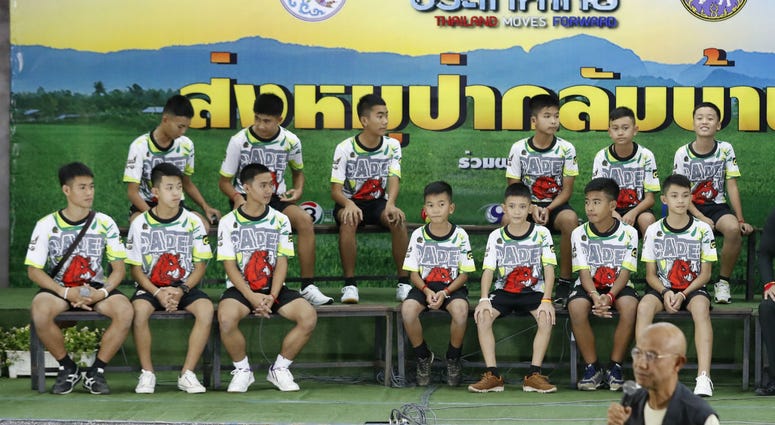 Members of the rescued soccer team and their coach sit during a press conference discussing their ordeal in the cave in Chiang Rai, northern Thailand, Wednesday, July 18, 2018. Members of the rescued soccer team and their coach sit during a press conference discussing their ordeal in the cave in Chiang Rai, northern Thailand, Wednesday, July 18, 2018.