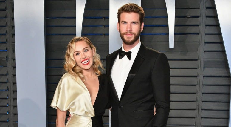 Miley Cyrus (L) and Liam Hemsworth attend the 2018 Vanity Fair Oscar Party hosted by Radhika Jones at Wallis Annenberg Center for the Performing Arts on March 4, 2018 in Beverly Hills, California. Miley Cyrus (L) and Liam Hemsworth attend the 2018 Vanity Fair Oscar Party hosted by Radhika Jones at Wallis Annenberg Center for the Performing Arts on March 4, 2018 in Beverly Hills, California.
