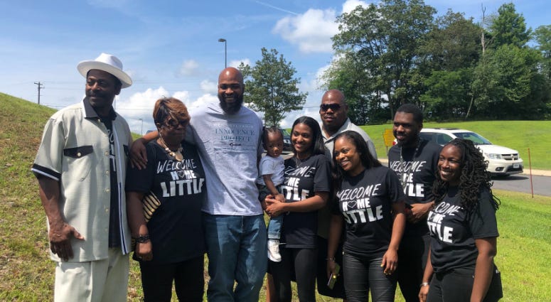 John Miller (center, gray shirt) is free with his family, July 31, 2019, after 22 years behind bars for a crime he didn't commit. John Miller and family