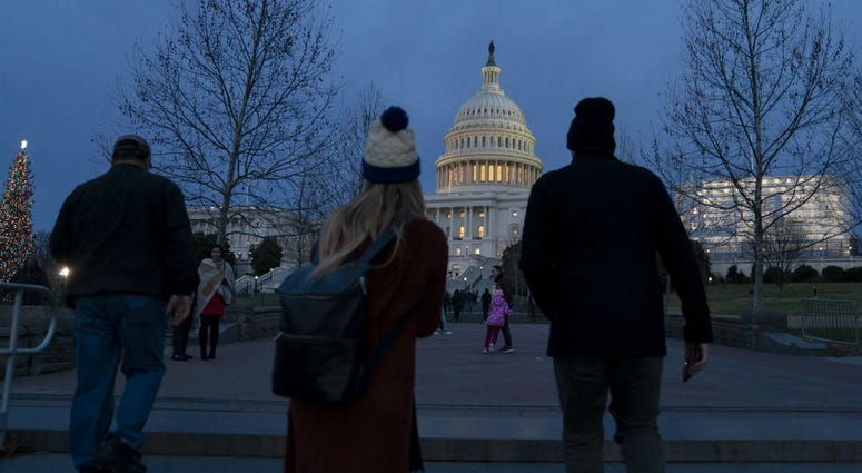 The Capitol is seen as New Year's Day comes to a close with the partial government shutdown in its second week, in Washington, Tuesday, Jan. 1, 2019. The Capitol is seen as New Year's Day comes to a close with the partial government shutdown in its second week, in Washington, Tuesday, Jan. 1, 2019.