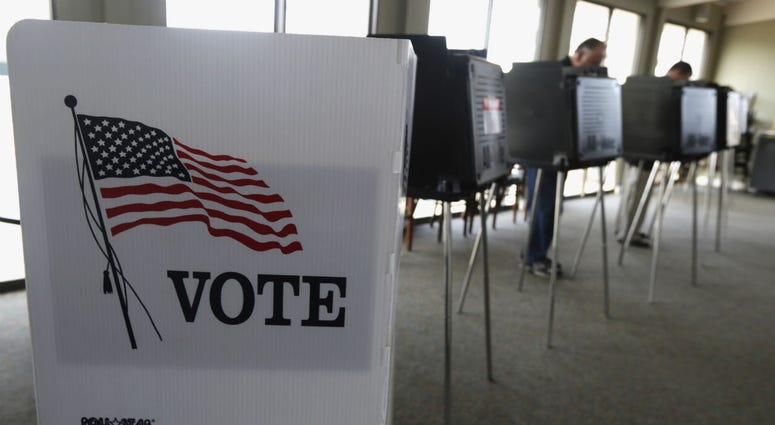 In this March 18, 2014 file photo, voters cast their ballots in Hinsdale, Ill. In this March 18, 2014 file photo, voters cast their ballots in Hinsdale, Ill.