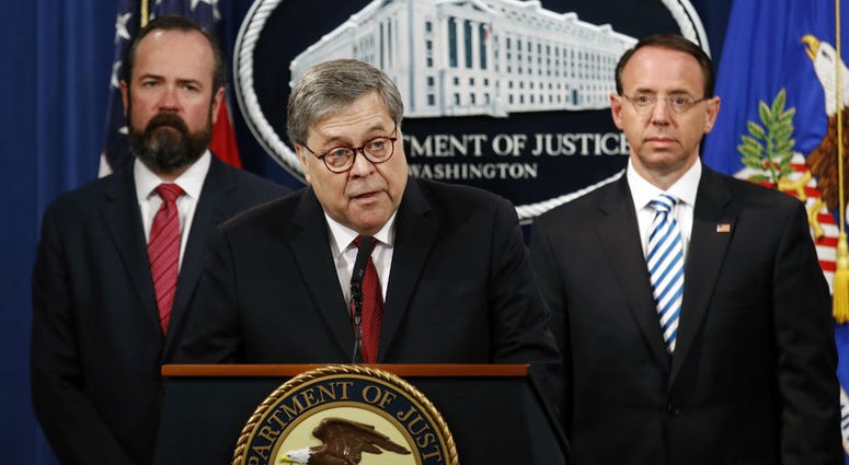 Attorney General William Barr speaks alongside Deputy Attorney General Rod Rosenstein, right, and acting Principal Associate Deputy Attorney General Edward O'Callaghan, left. Attorney General William Barr speaks alongside Deputy Attorney General Rod Rosenstein, right, and acting Principal Associate Deputy Attorney General Edward O'Callaghan, left.