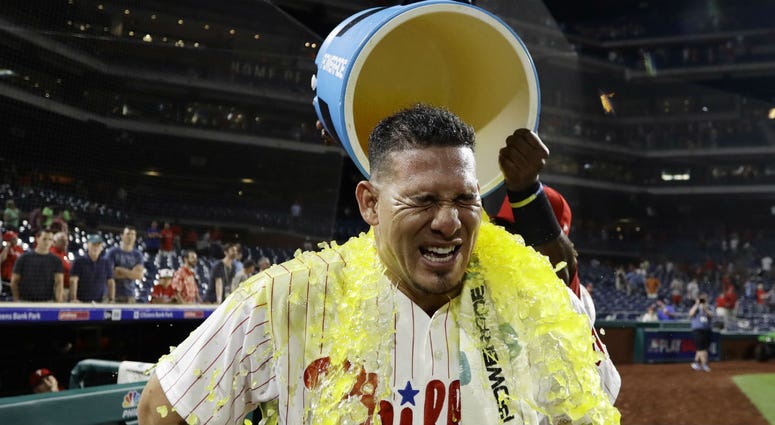 Philadelphia Phillies' Wilson Ramos is doused by Odubel Herrera after the Phillies' 7-4 win in a baseball game against the Boston Red Sox, Wednesday, Aug. 15, 2018, in Philadelphia. Philadelphia Phillies' Wilson Ramos is doused by Odubel Herrera after the Phillies' 7-4 win in a baseball game against the Boston Red Sox, Wednesday, Aug. 15, 2018, in Philadelphia.