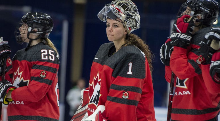 In this Nov. 10, 2018, file photo, Canada goaltender Shannon Szabados watch as U.S. players celebrate a win during the Four Nations Cup hockey gold-medal game in Saskatoon, Saskatchewan. In this Nov. 10, 2018, file photo, Canada goaltender Shannon Szabados watch as U.S. players celebrate a win during the Four Nations Cup hockey gold-medal game in Saskatoon, Saskatchewan.
