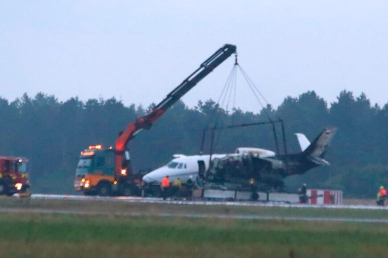 A private aircraft is recovered after it caught fire on landing at Aarhus Airport in Tirstrup, Denmark, Tuesday, Aug. 6, 2019. Flying from Oslo in Norway, the plane was believed to be carrying the manager and crew of pop singer Pink, who had given a conce