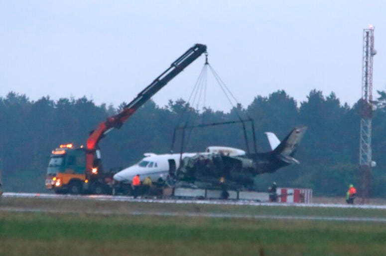 A private aircraft is recovered after it caught fire on landing at Aarhus Airport in Tirstrup, Denmark, Tuesday, Aug. 6, 2019. Flying from Oslo in Norway, the plane was believed to be carrying the manager and crew of pop singer Pink, who had given a conce