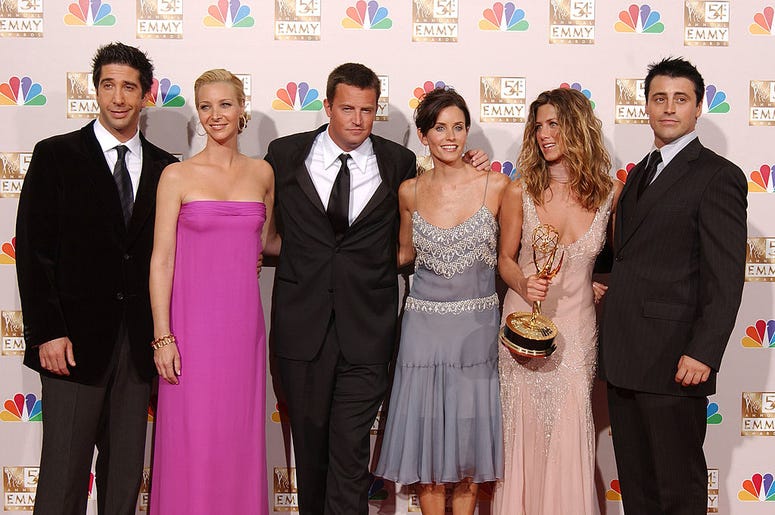 the cast of friends holding an award