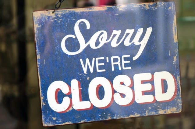 closed sign in a store entrance door