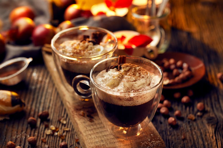 Spooky Hot Chocolate Hot chocolate with whipped cream, sprinkled with aromatic cinnamon in glass cups. Snack, brown.