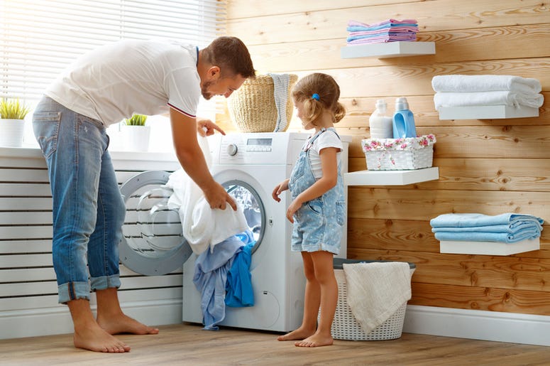 Happy family man father householder and child in laundry with Happy family man father householder and child in laundry with