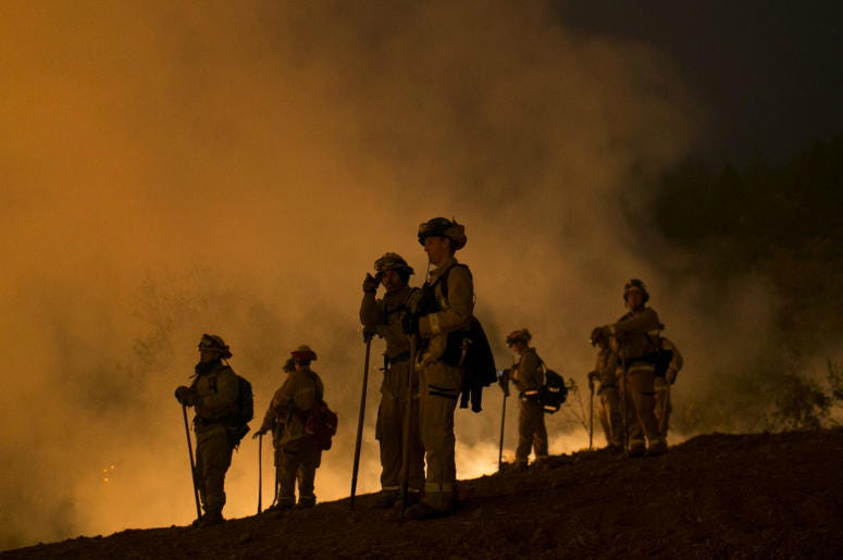 Firefighters hold a line in the Camp Fire with a control burn near Bloomer Hill in Butte County in California. Firefighters hold a line in the Camp Fire with a control burn near Bloomer Hill in Butte County in California.