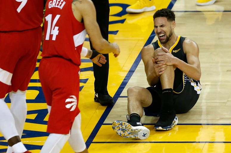 Golden State Warriors' Klay Thompson OAKLAND, CALIFORNIA - JUNE 13: Klay Thompson #11 of the Golden State Warriors reacts after hurting his leg against the Toronto Raptors in the second half during Game Six of the 2019 NBA Finals at ORACLE Arena on June 13, 2019 in Oakland, California. NOTE