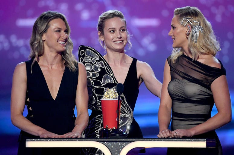 Brie Larson and stunt doubles Ingrid Kleinig and Joanna Bennett SANTA MONICA, CALIFORNIA - JUNE 15: (L-R) Brie Larson and stunt doubles Ingrid Kleinig and Joanna Bennett accept the Best Fight award for 'Captain Marvel' onstage during the 2019 MTV Movie and TV Awards at Barker Hangar on June 15, 2019 in Santa Monica, C