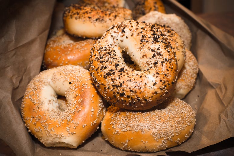 New York Style Bagels in bag. Food, nobody. Variety of assorted authentic New York style Bagels with seeds in a brown paper bag. (Photo credit: Littleny/Dreamstime)