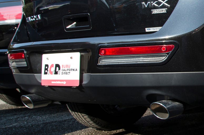 Temporary Paper License Plate Ryo Akaki, 23, details American cars on the lot at the Bubu Saitama dealership in Urawa, Saitama, Japan on Oct. 30, 2014. The dealership serves a niche market for people in Japan who like American cars, particularly sports cars or sport utility vehicles.