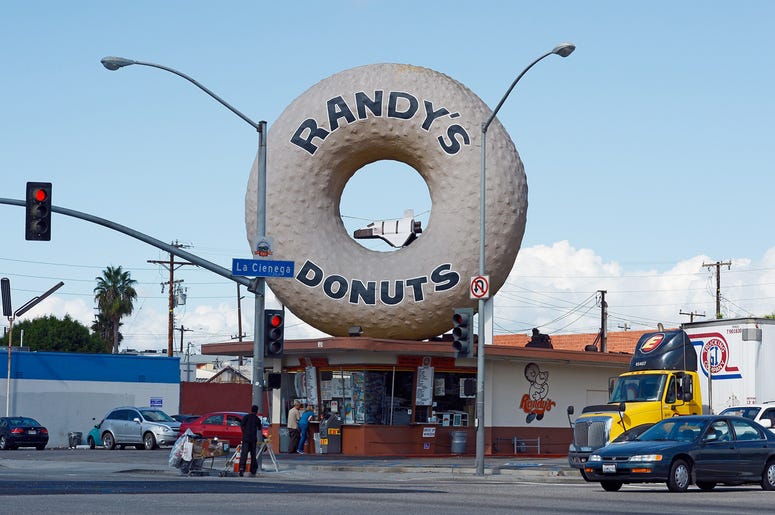 Randy's Donuts LOS ANGELES, CA - OCTOBER 10: A toy space shuttle placed in the dounut hole of Randy's Donuts in preparation of the ground transport of the space shuttle Endeavour on October 10, 2012 in Los Angeles, California. The orbitor will stop in front of the donut