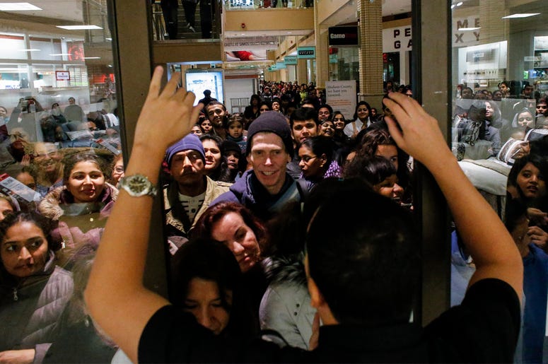 Black Friday lines to enter a store NEWPORT, NJ - NOVEMBER 27: People waits in line to go shopping at the to JCPenney store at the Newport Mall on November 27, 2014 in Jersey City, New Jersey. Black Friday sales, which now begin on the Thursday of Thanksgiving, continue to draw shoppers out