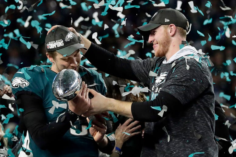 Philadelphia Eagles quarterback Carson Wentz, right, hands the Vincent Lombardi trophy to Nick Foles Philadelphia Eagles quarterback Carson Wentz, right, hands the Vincent Lombardi trophy to Nick Foles