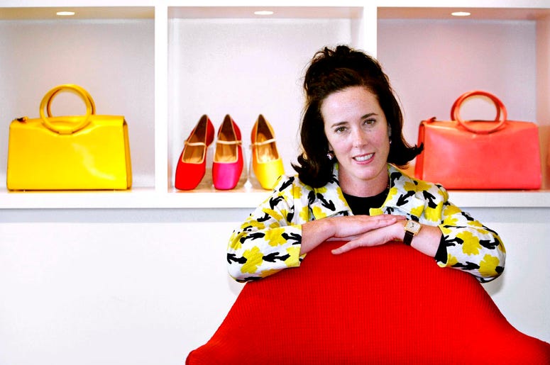 AP18156579700364 In this May 13, 2004 file photo, designer Kate Spade poses with handbags and shoes from her next collection in New York. Law enforcement officials say Tuesday, June 5, 2018, that New York fashion designer Kate Spade has been found dead in her apartment in