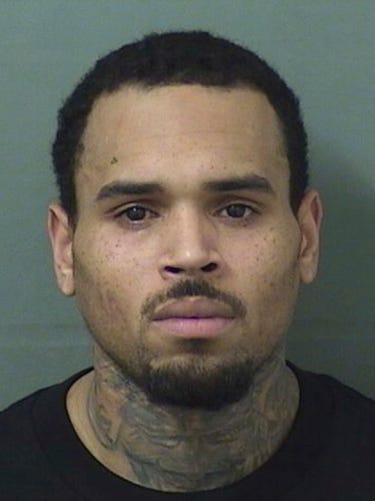 AP18187423277395 This booking photo provided by Balm Beach County Sheriff's Office shows Chris Brown. The singer walked off stage after his concert in Florida and into the hands of waiting sheriff’s deputies, who arrested him on a felony battery charge and booked him into