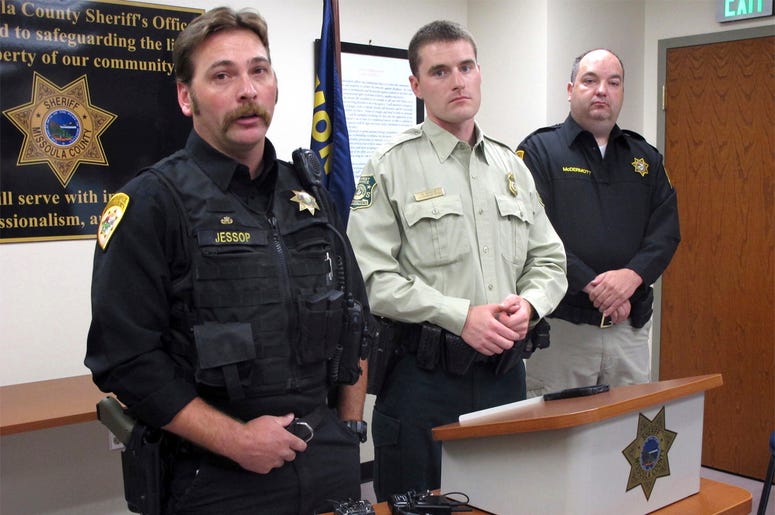 AP18191757553982 From left, Missoula County Sheriff's Deputy Ross Jessop, U.S. Forest Service Law Enforcement Officer Nick Scholz and Sheriff T.J. McDermott answer questions on Tuesday, July 10, 2018, in Missoula, Mont., about a baby found in the woods at least nine hours