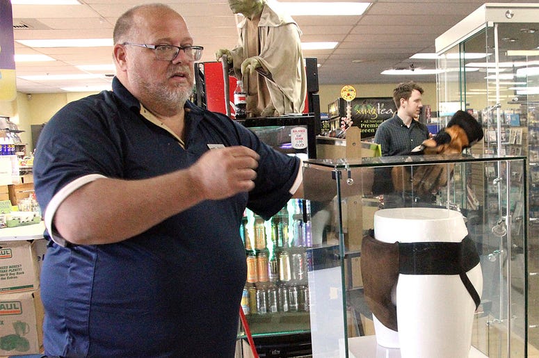 AP18199657978131 In this May 2, 2018 file photo, Blockbuster Alaska general manager Kevin Daymude moves a display case featuring the jockstrap worn by actor Russell Crowe in the 2005 movie "Cinderella Man" at a Blockbuster video store in Anchorage, Alaska. Everything in t