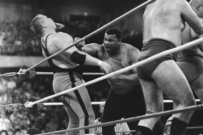 AP18225704782048 This April 7, 1986, file photo shows Chicago Bears' William Perry, right, landing a punch on pro wrestler Jim "The Anvil" Neidhart during the "Over-The-Top-Rope" battle royal at Wrestlemania 2 in Rosemont, Ill. Neidhart, who joined with Bret Hart to form
