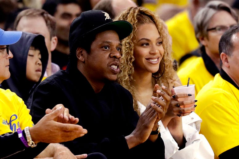 AP18285318029743 In this April 28, 2018, file photo, Jay-Z and Beyonce watch Game 1 of an NBA basketball second-round playoff series between the Golden State Warriors and the New Orleans Pelicans in Oakland, Calif. Beyonce paid homage to a high-profile music executive bei