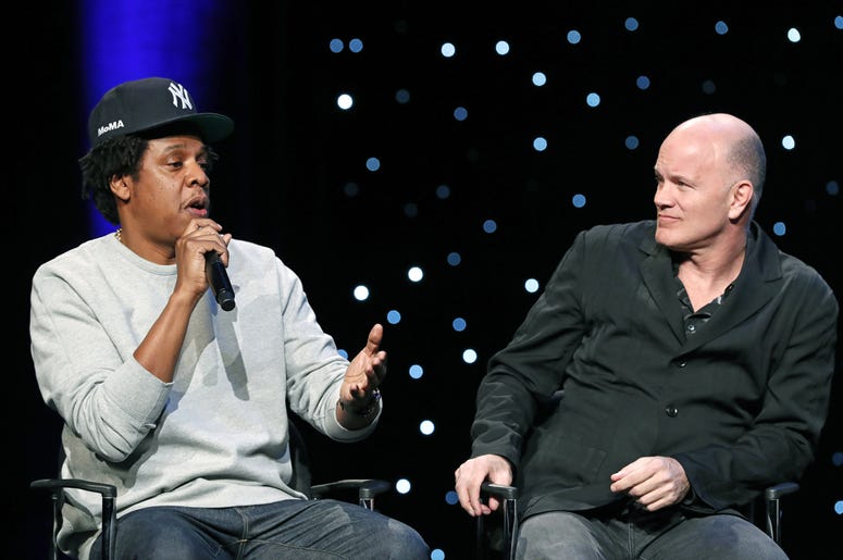 AP19023658628303 Rapper and business mogul Shawn "Jay-Z" Carter, left, speaks as Michael Novogratz, founder and CEO Galaxy Digital, listens during the launch of a partnership among entertainment moguls, recording artists, business and sports leaders who hope to transform