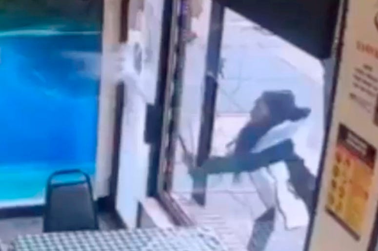 AP19040649910316 In this Jan. 15, 2019 image taken from surveillance video, a woman smashes the windows of "Back Home Restaurant" in the Bronx borough of New York. Police say that she became upset after ordering a patty and was told that the restaurant had run out of them