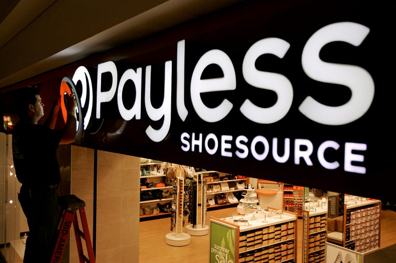 AP19050702770259 In this May 18, 2006, file photo a worker puts the finishing touches on a sign unveiling the company's new look at a Payless Shoesource store at a mall in Independence, Mo. Payless ShoeSource has filed for Chapter 11 bankruptcy protection and is shutterin