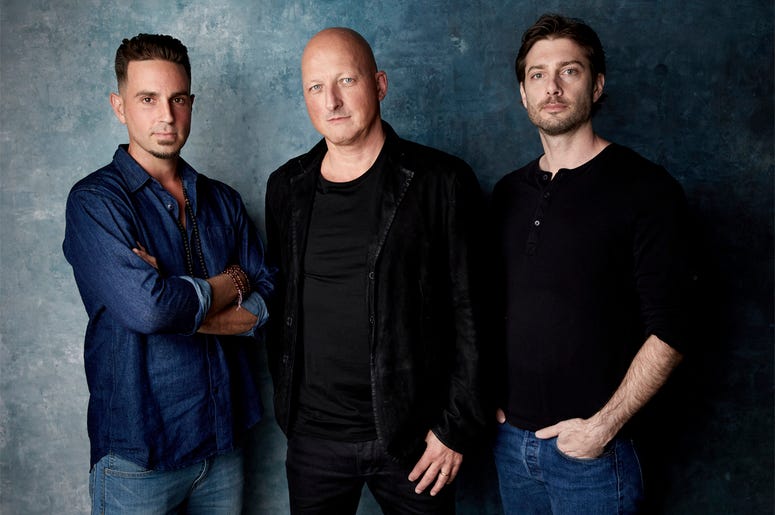AP19058603536848 In this Jan. 24, 2019, file photo, Wade Robson, from left, director Dan Reed and James Safechuck pose for a portrait to promote the film "Leaving Neverland" during the Sundance Film Festival in Park City, Utah. The documentary premiered at the Sundance Fi