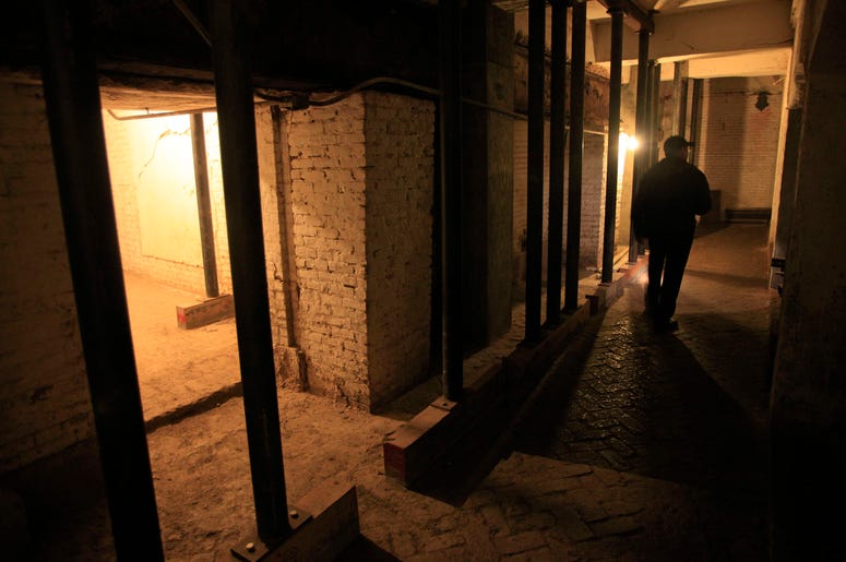 AP19065732605359 In this July 7, 2011, file photo, Jim Breeden of the Golden Gate National Parks Conservancy, walks through the dungeons below the main cell house during a night tour on Alcatraz Island in San Francisco. (AP Photo/Eric Risberg)
