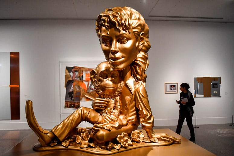 AP19080418465680 The sculpture 'Michael Jackson and Bubbles' from US artist Paul McCarthy' is presented at a preview of the exhibition 'Michael Jackson: On The Wall' at the Bundeskunsthalle museum in Bonn, Germany, Thursday, March 21, 2019. The exhibition around the contr