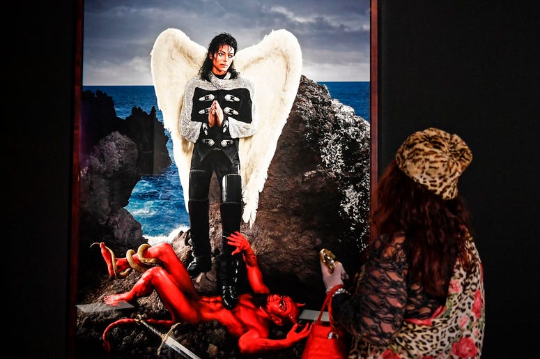 AP19080418671479 A visitor watches the picture 'Archangel Michael: And no message could have been any clearer' from US artist David LaChapelle at a preview of the exhibition 'Michael Jackson: On The Wall' at the Bundeskunsthalle museum in Bonn, Germany, Thursday, March 21