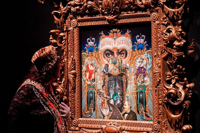 AP19080419347700 A visitor watches the picture 'The King Of Pop' from US artist Mark Ryden at a preview of the exhibition 'Michael Jackson: On The Wall' at the Bundeskunsthalle museum in Bonn, Germany, Thursday, March 21, 2019. The exhibition around the controversial icon