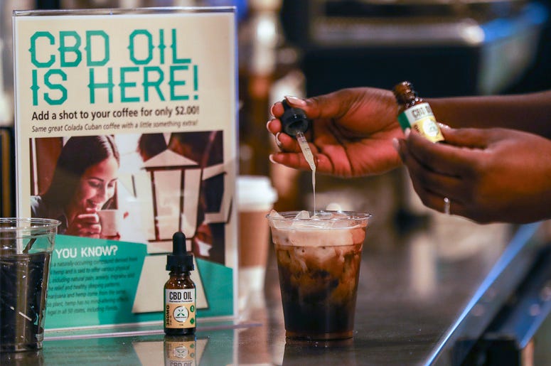 AP19094657264805 In this Jan. 4, 2018, file photo, a worker adds cannabidiol (CBD) to a drink at a coffee shop in Fort Lauderdale, Fla. (Jennifer Lett/South Florida Sun-Sentinel via AP, File)