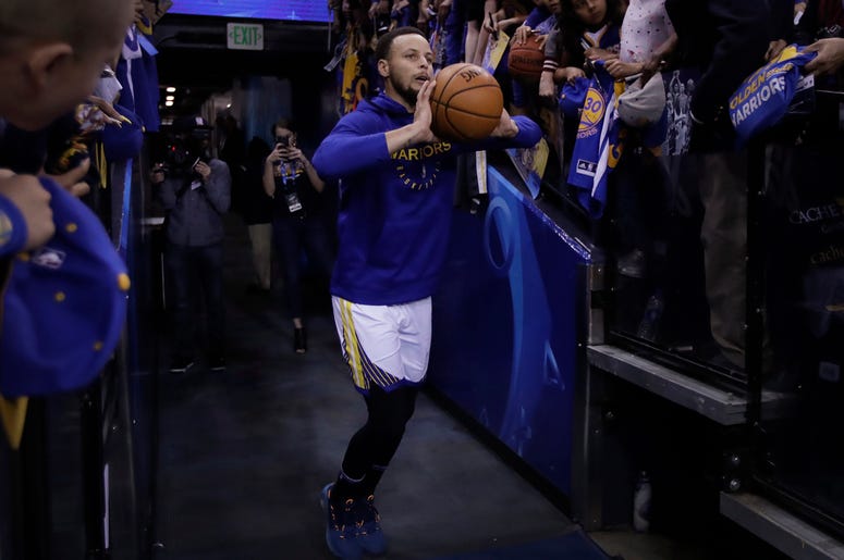 AP19099859876038 In this Sunday, April 7, 2019, photo, Golden State Warriors' Stephen Curry shoots from the players' entrance tunnel prior to the team's NBA basketball game against the Los Angeles Clippers in Oakland. (AP Photo/Ben Margot)