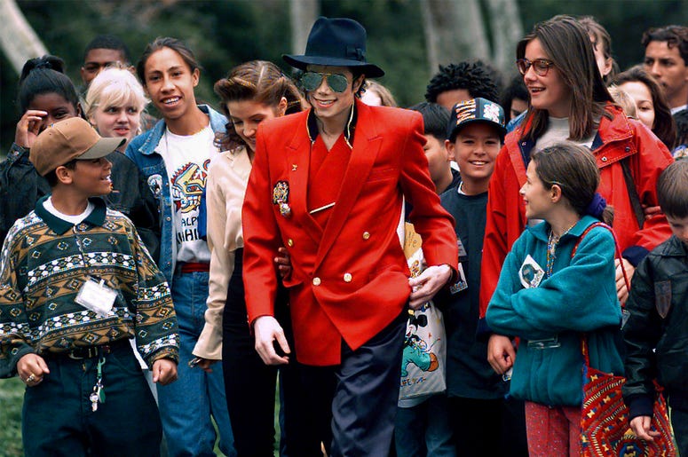 AP19106483295861 In this April 18, 1995, file photo, pop star Michael Jackson and Lisa Marie Presley, behind him at left, walk with children that were invited guests at his Neverland Ranch home in Santa Ynez, California. (Photo credit: AP Photo/Mark J. Terrill, File)