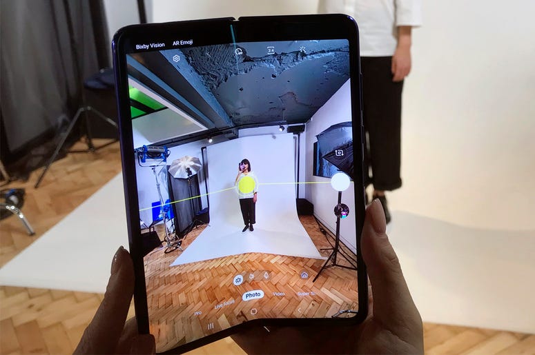 AP19106514275440 In this April 16, 2019, photo, a model holds a Samsung Galaxy Fold smart phone to her face, during a media preview event in London. (AP Photo/Kelvin Chan)