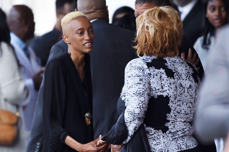 AP19126637961132 Justice Maya Singleton, left, daughter of the late film director John Singleton, greets guests at a memorial service for Singleton at Angelus Funeral Home, Monday, May 6, 2019, in Los Angeles. Singleton died on April 29 following a stroke. (AP Photo/Chris