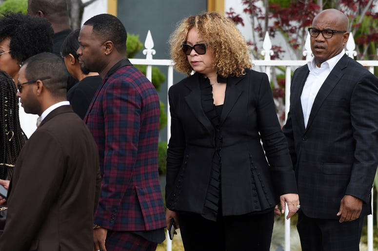 AP19126641761642 Costume designer Ruth Carter, second from right, arrives at a memorial service for the late film director John Singleton at Angelus Funeral Home, Monday, May 6, 2019, in Los Angeles. Singleton died on April 29 following a stroke. (AP Photo/Chris Pizzello)