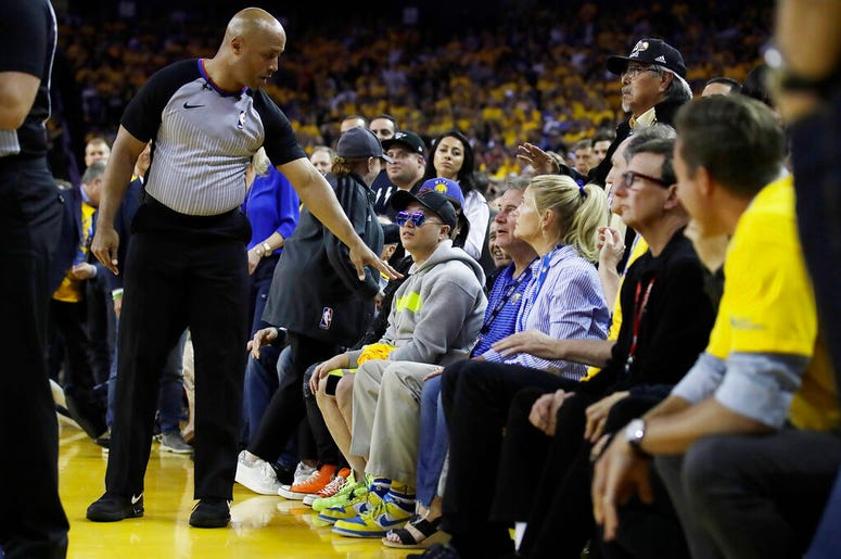 Referee Marc Davis gestures toward Golden State Warriors investor Mark Stevens Referee Marc Davis gestures toward Golden State Warriors investor Mark Stevens