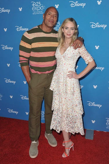 AP19236788081044 Dwayne Johnson, left, and Emily Blunt attend the Go Behind the Scenes with the Walt Disney Studios press line at the 2019 D23 Expo on Saturday, Aug. 24, 2019, in Anaheim, Calif. (Photo by Richard Shotwell/Invision/AP)