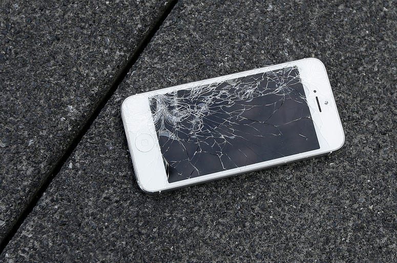 AP19241538579907 This Aug. 26, 2015 photo shows an Apple iPhone with a cracked screen after a drop test from the DropBot, a robot used to measure the sustainability of a phone to dropping, at the offices of SquareTrade in San Francisco. (AP Photo/Ben Margot, File)
