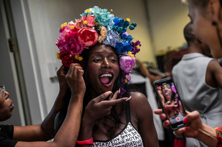 AP19248862954381 A makeup artist works on a model backstage at the dapperQ fashion show at the Brooklyn Museum on Thursday, Sept. 5, 2019, in New York. (AP Photo/Jeenah Moon)