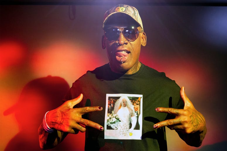 AP19253410851019 In this Monday, Sept. 9, 2019, photo, former NBA star Dennis Rodman poses wearing a T-shirt depicting himself in a wedding dress at a 1996 book promo event, in Los Angeles. (AP Photo/Damian Dovarganes)