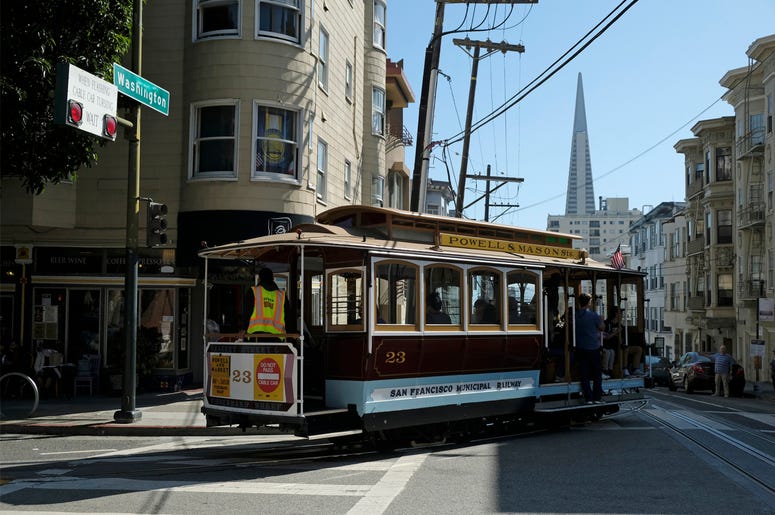 AP19254687538187 A cable car turns onto Washington Street with the Transamerica Pyramid in the background Wednesday, Sept. 11, 2019, in San Francisco. (AP Photo/Eric Risberg)