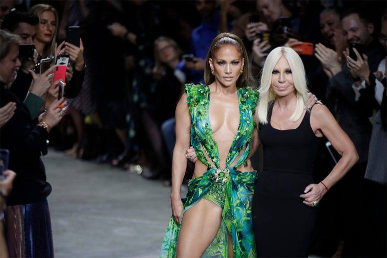 AP19263704290439 Actress Jennifer Lopez, left, and designer Donatella Versace accept applause at the conclusion of the Versace Spring-Summer 2020 collection, unveiled during the fashion week, in Milan, Italy, Friday, Sept. 20, 2019. (AP Photo/Luca Bruno)